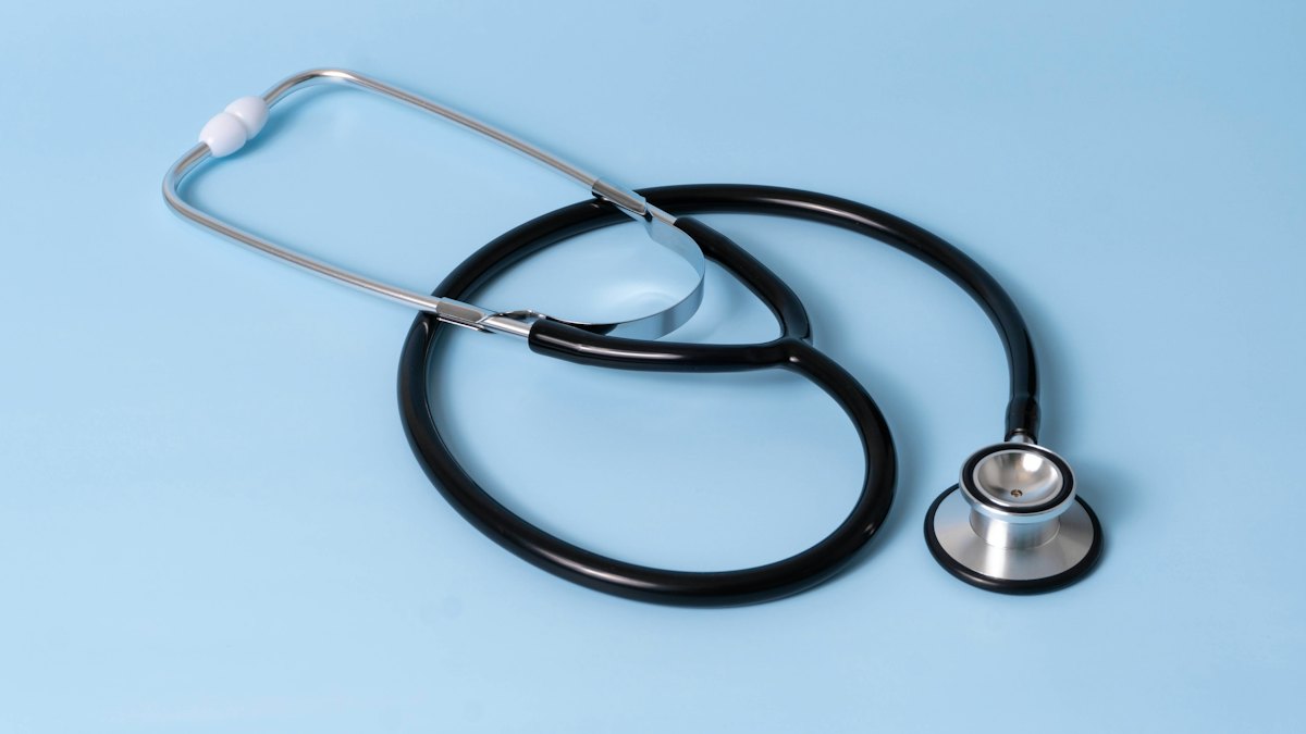 A stethoscope on a light blue background